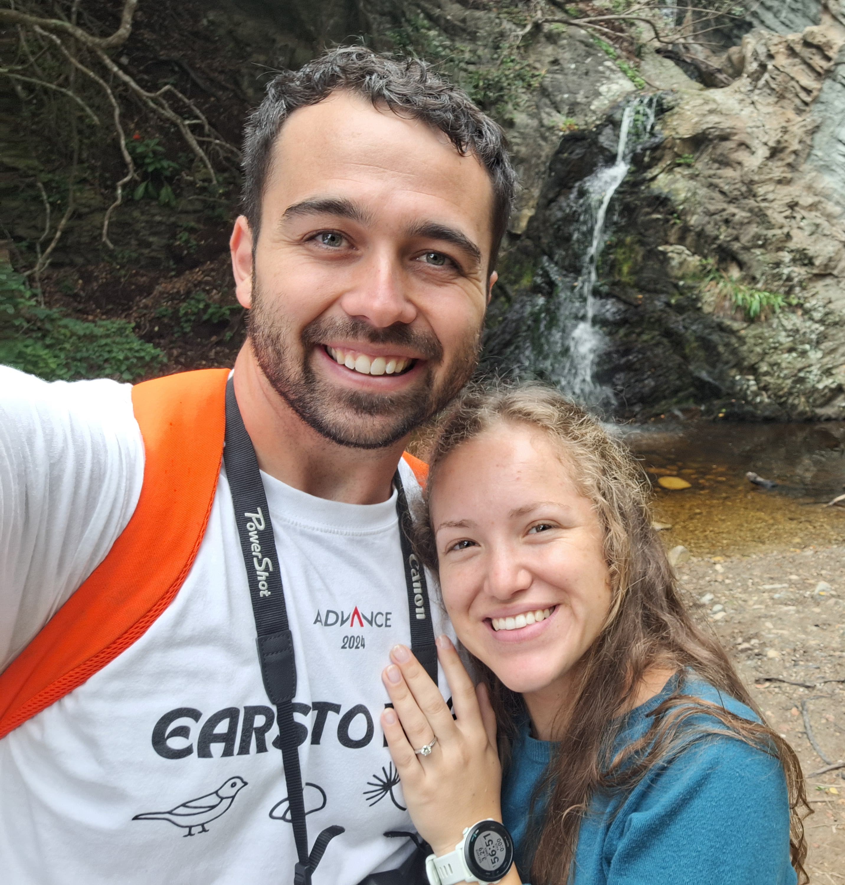 Bryce Biggs smiling beside a waterfall